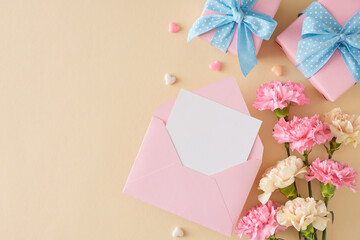 Mother's Day present concept. Top view photo of open blank envelope gift boxes bunch of carnation flowers and small hearts on light beige background. Flat lay with empty space for greeting or text