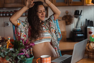 Young mother to be feeling happy, dancing around at home.