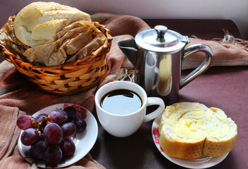 Breakfast in Brazil. Black coffee, bread with butter and fruit.