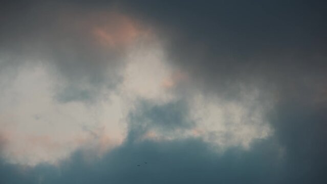 Dark clouds rolling in, storm incoming, grey clouds at sunset, 4K cloud video golden hour, rain storm