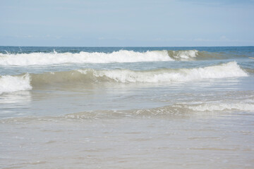 Waves breaking on the shore at the beach