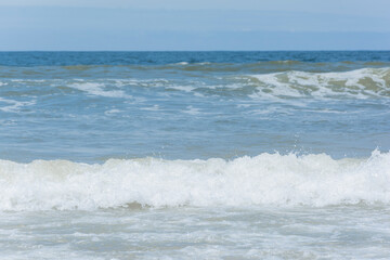 Fototapeta na wymiar Waves breaking on the shore at the beach