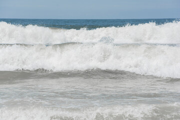 Waves breaking on the shore at the beach