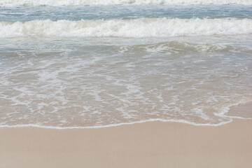 Waves breaking on the shore at the beach