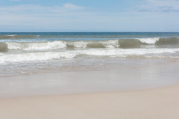 Waves breaking on the shore at the beach