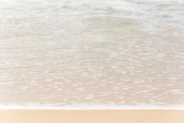 Waves breaking on the shore at the beach