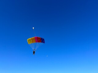 Skydiver at the resort with an instructor lands.