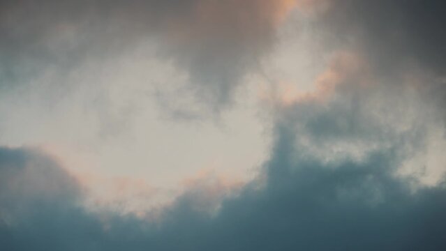 Dark clouds rolling in, storm incoming, grey clouds at sunset, 4K cloud video golden hour, rain storm