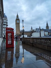 Fototapeta na wymiar Big Ben, a telephone box and their reflections on a rainy day in London