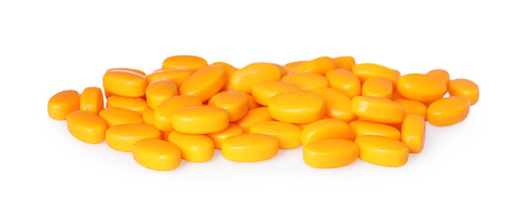 Tasty orange dragee candies on white background