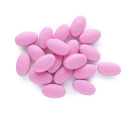 Obraz na płótnie Canvas Tasty pink dragee candies on white background, top view