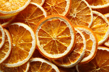Many dry orange slices as background, top view