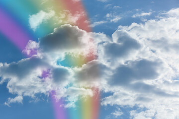 Beautiful sky with bright rainbow and fluffy clouds