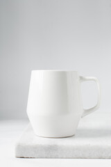 Large white mug on a marble tray, white coffee cup