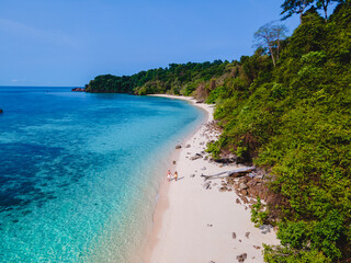 a couple walking at the beach of Koh Kradan Island in Thailand