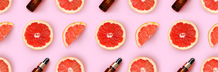 Fresh grapefruit slices on pink background