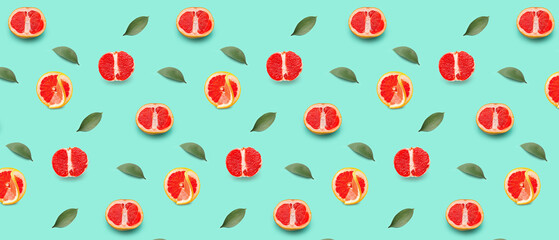 Many ripe grapefruits on turquoise background. Pattern for design