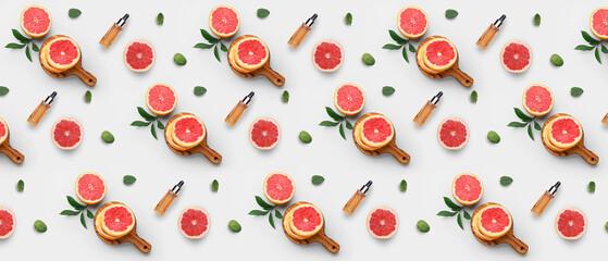 Many bottles of grapefruit essential oil on white background. Pattern for design