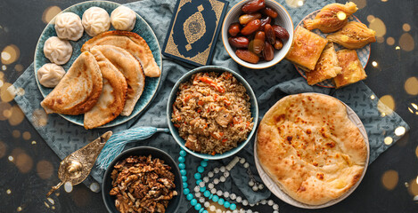 Traditional Eastern dishes with Quran book on dark background