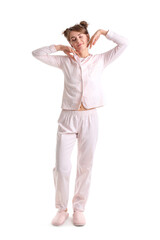 Sleepy young woman in pajamas on white background
