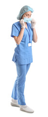 Female nurse putting on medical mask against white background