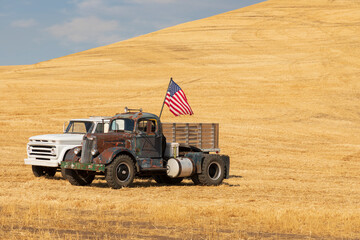 USA, Washington State, Whitman County, Palouse. White Super Power Truck, 1946 sits next to a 1965...
