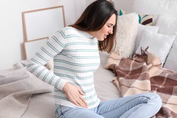 Young woman with appendicitis at home