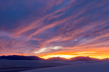 Fototapeta na wymiar USA, New Mexico, White Sands National Monument. Sunset clouds over white sand desert.
