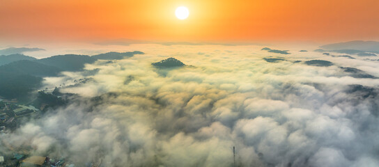 Aerial view of Xuan Tho suburbs near Da Lat city at morning with misty and sunrise sky. This place is considered most beautiful and peaceful place to watch sunrise in highlands of Vietnam © huythoai