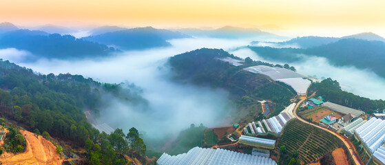 Aerial view of Xuan Tho suburbs near Da Lat city at morning with misty and sunrise sky. This place...