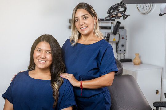Cheerful Women Dentists Standing Side by Side in their Clinic