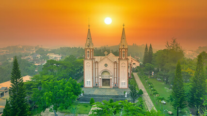 Tan Hoa parish church in Bao Loc, Vietnam on a foggy morning, a place for parishioners to come to confession and pray for peace for their families - obrazy, fototapety, plakaty