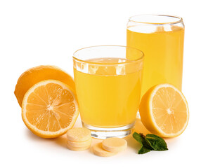 Glasses of vitamin C effervescent tablet dissolved in water and lemons isolated on white background