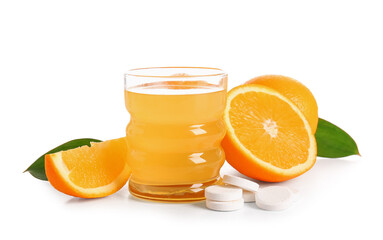 Glass of vitamin C effervescent tablet dissolved in water and oranges isolated on white background