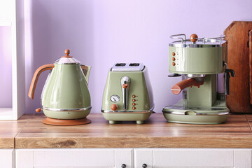 Electric kettle, toaster and coffee machine on counter in kitchen