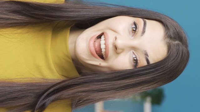 Vertical Video Of Confused young woman is astonishingly rejoicing and happy. 