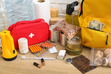 Necessities for emergency bag on wooden table