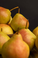 A yellow ripe pear with a red side on the table