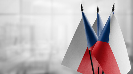 Small flags of the Czechia on an abstract blurry background