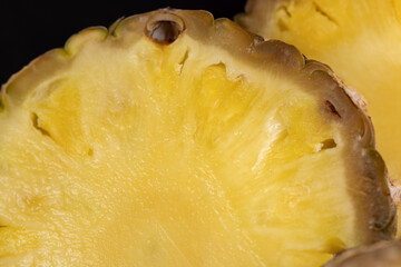 sliced pulp of peeled ripe pineapple , close up