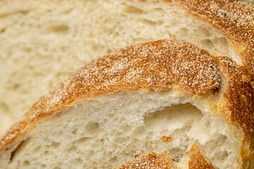 A cut loaf of round-shaped wheat bread