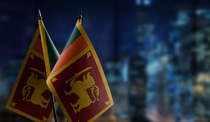Small flags of the Sri Lanka on an abstract blurry background