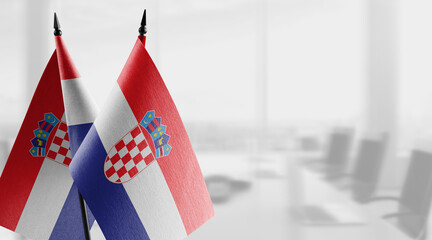 Small flags of the Croatia on an abstract blurry background