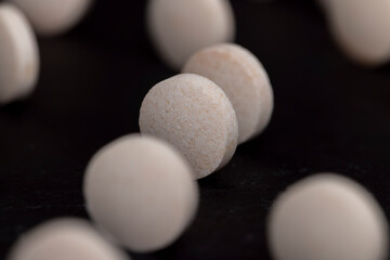 White and yellow medical medicines on a black background