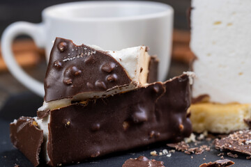 Fresh sweet cake with milk taste and aroma in chocolate glaze