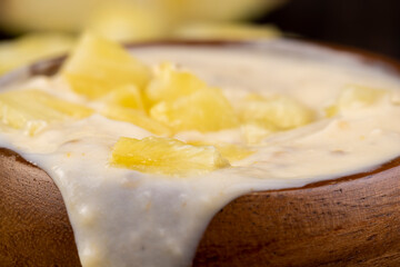 milk pineapple yogurt with pieces of pineapple and other fruits