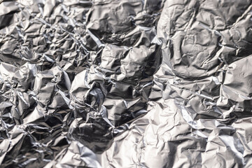old used crumpled aluminum foil , close up