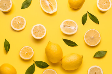 Composition with fresh lemons on yellow background