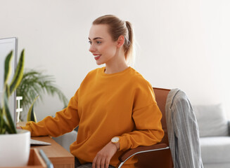 Female student studying online with computer at home