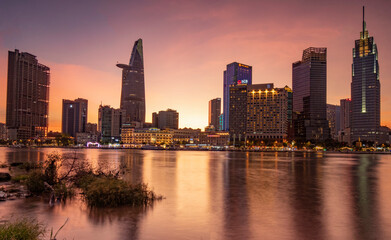 Fototapeta na wymiar The sunset sun shines on buildings in downtown Ho Chi Minh city, Vietnam.